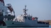 FILE - Migrants arrive in Porto Empedocle, Sicily, aboard two military ships after being transferred from the island of Lampedusa, where a number of small boat carrying migrants arrived in the last days, July 27, 2020.
