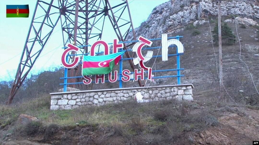 An image grab taken from a video made available on the official website of the Azerbaijani Defense Ministry Nov. 9, 2020, shows an Azeri flag on the side of a road entering the town of Shushi (Shusha) in the breakaway region of Nagorno-Karabakh.