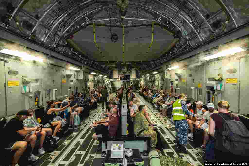 Australian citizens are seen on board a Royal Australian Air Force C-17A transport aircraft at Bauerfield International Airport in Port Vila, in a repatriation flight following the Vanuatu earthquake.
