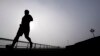 FILE - A man jogs at Pier A Park in Hoboken, New Jersey, Jan. 15, 2014. Atherosclerosis, or calcium deposits, in the cardiac arteries of young people have been found to dramatically shorten life expectancy, a new study found.