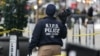A Crime Scene Unit officer photographs the scene where CEO of UnitedHealthcare Brian Thompson, 50, was shot as he entered the New York Hilton early on December 4, 2024 in New York.