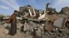 Seorang pria Palestina memeriksa kerusakan di lokasi serangan Israel terhadap rumah-rumah di Khan Younis di selatan Jalur Gaza, 12 Desember 2023. (Foto: REUTERS/Ibraheem Abu Mustafa )