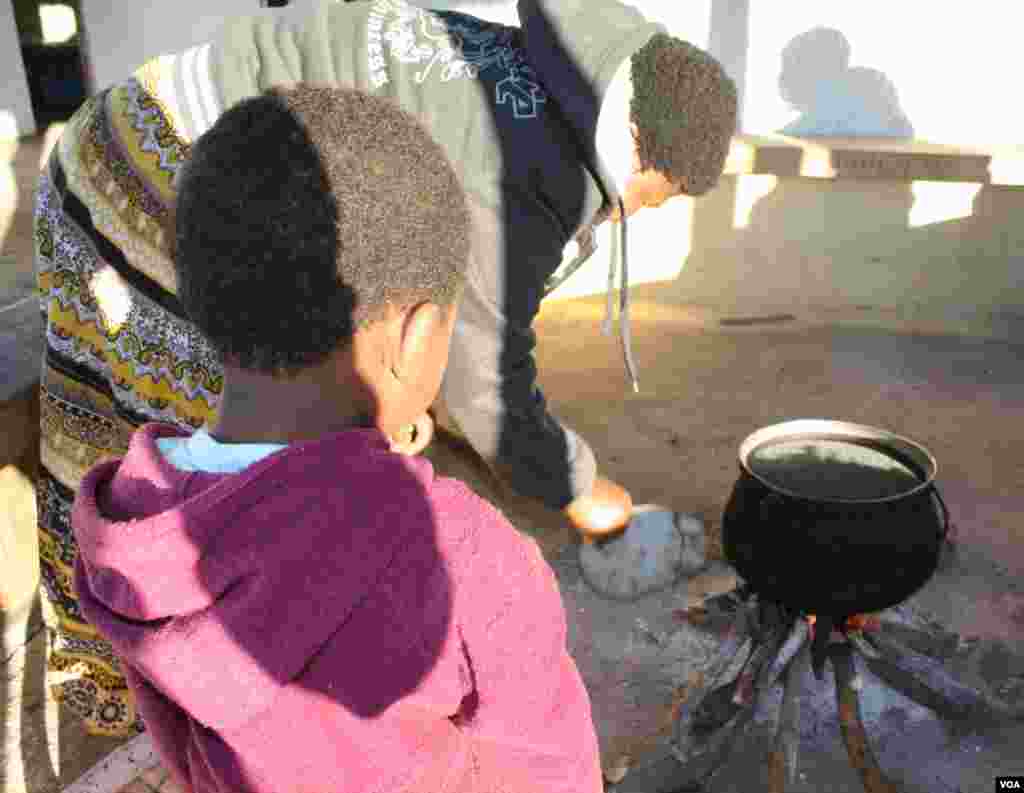 Lungiswa was burned when she was younger, but she has since overcome her fear of fire and cooking (VOA/ D. Taylor)