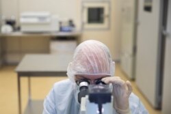 FILE - A specialist works at a pharmaceutical plant in Zelenograd near Moscow, Russia, Sept. 18, 2020.
