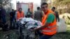 Medics transport a body at the site of explosions near the Iranian embassy in Beirut November 19, 2013. Two explosions targeting the Iranian embassy hit the Lebanese capital Beirut on Tuesday, security sources said, killing at least 23 people and damaging buildings in the embassy compound, Lebanese sources said.