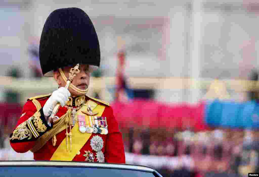 Thailand's King Maha Vajiralongkorn reviews the guard of honour, during a trooping of the colours ceremony to honor his 72nd birthday in Bangkok, Thailand.