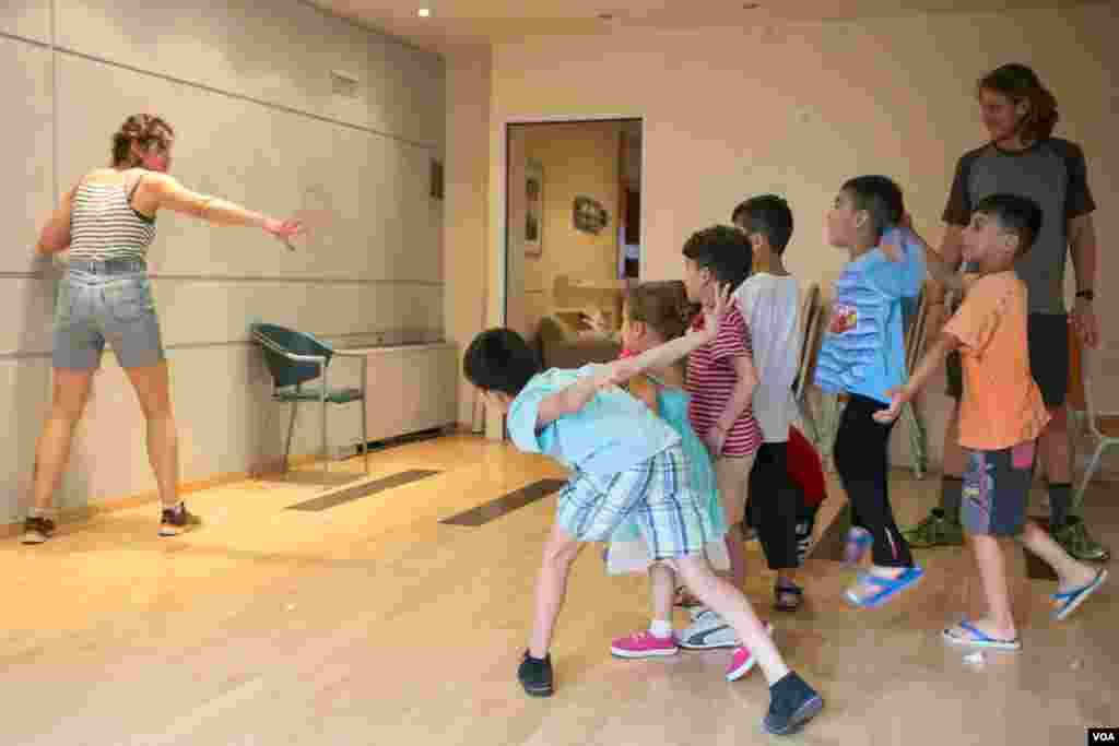 Children play with one of the volunteers in the hotel. About 180 children live here. (J. Owens/VOA)