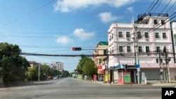 FILE - An empty street on Friday, Dec. 10, 2021, in Mandalay, central Myanmar. Soe Naing, a local freelance photographer in Myanmar, has died in military custody after being arrested last week during the course of his work, colleagues and a friend of his family said Tuesday Dec. 