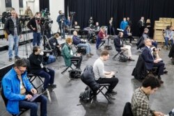 Journalists practice social distancing during a news conference with New York Gov. Andrew Cuomo at the Jacob Javits Center that will house a temporary hospital in response to the COVID-19 outbreak, March 24, 2020, in New York.