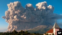 Mount Sinabung spews volcanic material during an eruption in Karo, North Sumatra, Indonesia, March 2, 2021. 