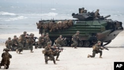 U.S. Marines with Amphibious Assault Vehicles take a part in a landing operation during Exercise Baltops 2018 along the Baltic Sea near the Lithuania village of Nemirseta, June 4, 2018. The U.S.-led exercise features 18,000 soldiers from 19 primarily NATO countries.