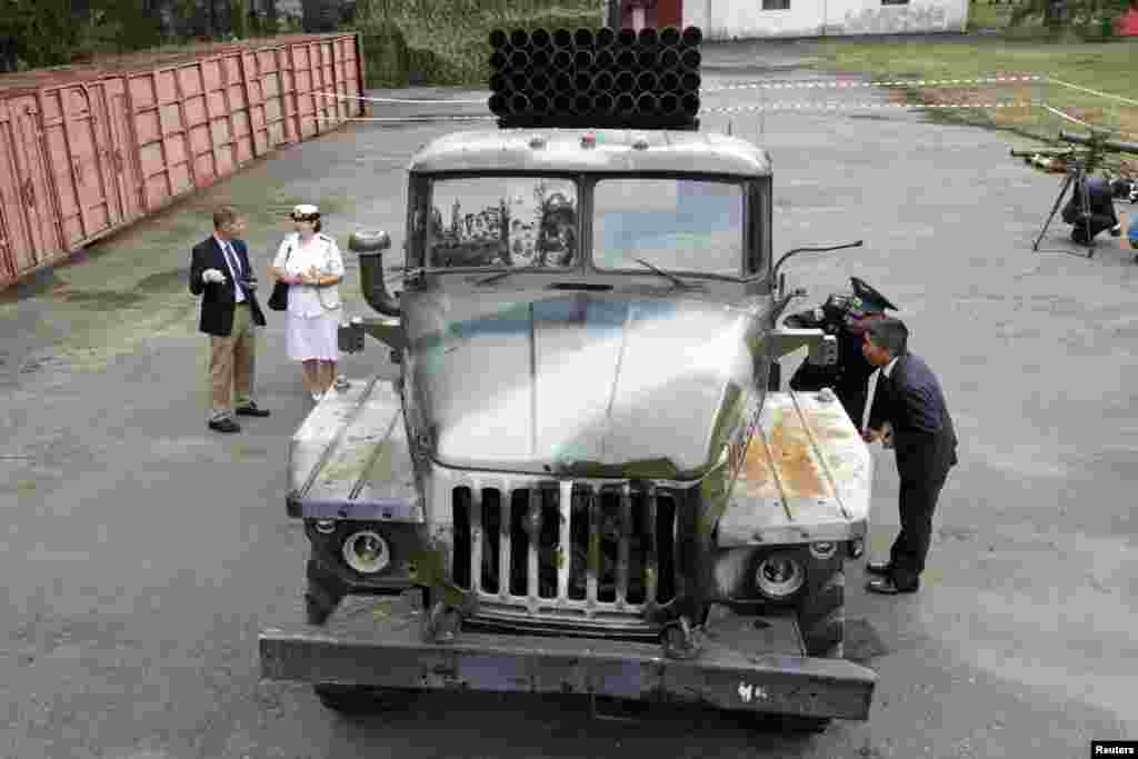 A foreign military attache inspects a multiple rocket launcher from pro-Russian separatists in the eastern region of Ukraine, Aug. 29, 2014. 
