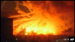 This photo provided by Ukrainian Emergency Situations Ministry press service shows a fire raging at a military ammunition depot in Balaklia near Khrakiv in Ukraine, March 23 2017. 