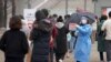 A medical worker holds a sign for visitors to prepare for the coronavirus tests at a temporary screening clinic for coronavirus in Seoul, South Korea on Dec. 10, 2021. 