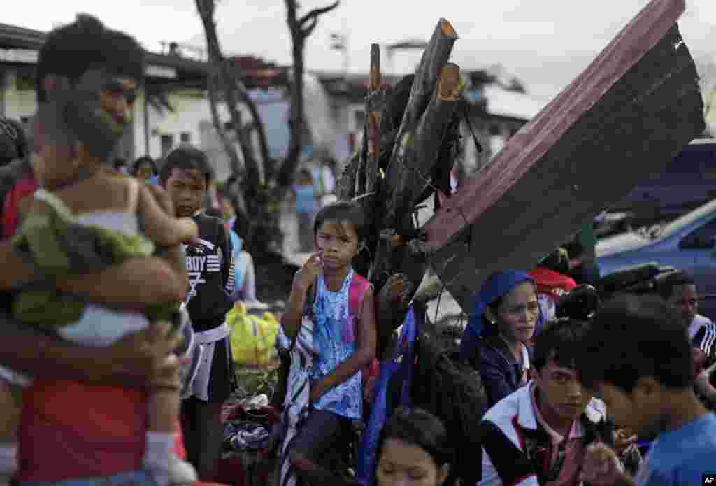 Typhoon Haiyan survivors wait for their evacuation flights at the airport in Tacloban, Philippines, Nov. 21, 2013.
