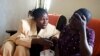 FILE - Apollonie, a Congolese counselor, speaks with a rape victim in the HEAL Africa hospital in Goma.