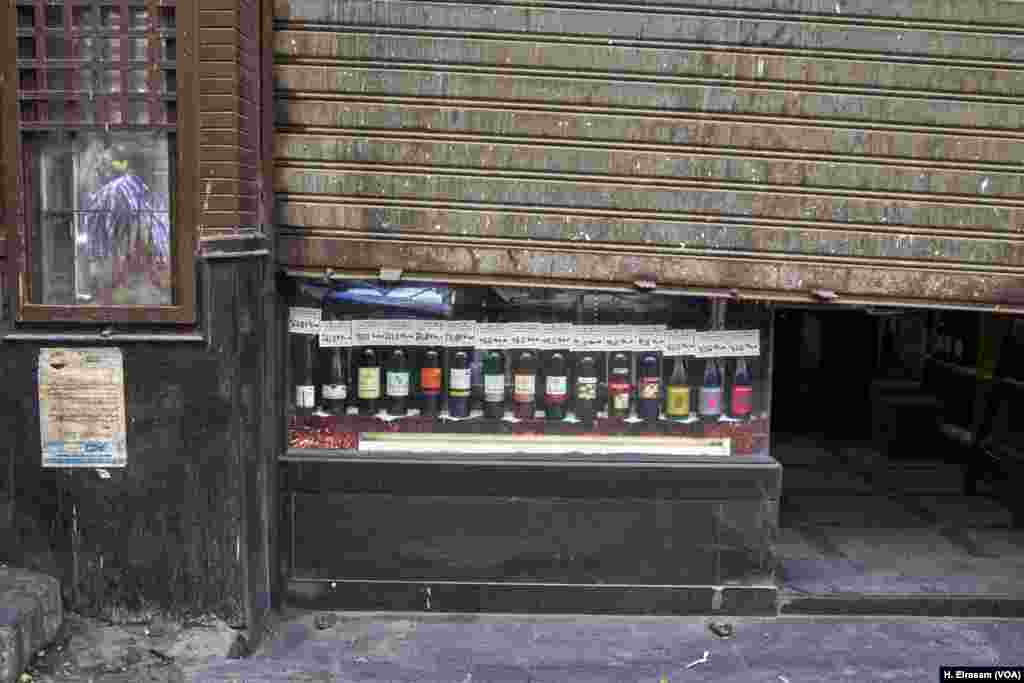 Islam prohibits the consumption of alcohol, but in Egypt as Ramadan ends, one of the lesser-known traditions is the reopening of liquor stores. This liquor store is opening its door halfway, a sign of being ready to work.