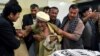 FILE - A father of a member of the Hazara community who was killed by unidentified gunmen mourns the death of his son at a hospital in Quetta, Pakistan, April 22, 2018. 