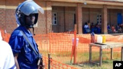 A police officer stand guards at a newly established Ebola response center in Beni, Democratic Republic of Congo, Aug. 10, 2018.