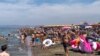 People enjoy the beach in Fregene, a fashionable sea resort some 30km (19 miles) north of Rome, July 26, 2020. 