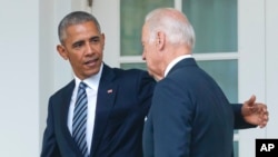 FILE - Nov. 9, 2016, President Barack Obama, accompanied by Vice President Joe Biden, who is viewed with skepticism among some Latinos for his ties to deportation policies during the Obama administration.