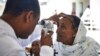 Ethiopian ophthalmologist Dr. Tilahun Kiros examines a patient's eyes at the Quiha Eye Hospital Vision Center in Mekelle, Ethiopia