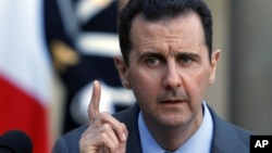 Syria President Bashar al-Assad addresses reporters following his meeting with French President Nicolas SarkozyThursday Dec. 9, 2010. 
