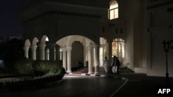FILE - Members of a Taliban negotiating team enter the venue hosting U.S.-Taliban talks in the Qatari capital Doha, Aug. 29, 2019.