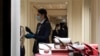 Shop assistants wear masks in a shop in downtown Rome, Jan. 31, 2020. 