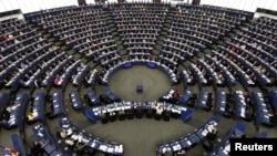 FILE - Members of the European Parliament take part in a voting session at the European Parliament in Strasbourg, Sept. 10, 2013. 