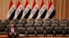 FILE - Iraqi Prime Minister Haider al-Abadi sits during a parliamentary session to vote on Iraq's new government at the parliament headquarters in Baghdad, Sep. 8, 2014. Negotiations between the country’s highly polarized political factions have failed to produce a way forward for Iraq.