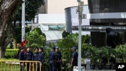 Police officers patrol the perimeter of the St. Regis Hotel in Singapore, June 11, 2018, ahead of the summit between U.S. President Donald Trump and North Korean leader Kim Jong Un.