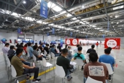 FILE - People wait to be vaccinated against the coronavirus disease (COVID-19) during a vaccination session organized by the local Taiwan Affairs Office in Nanchang, Jiangxi province, China June 4, 2021.