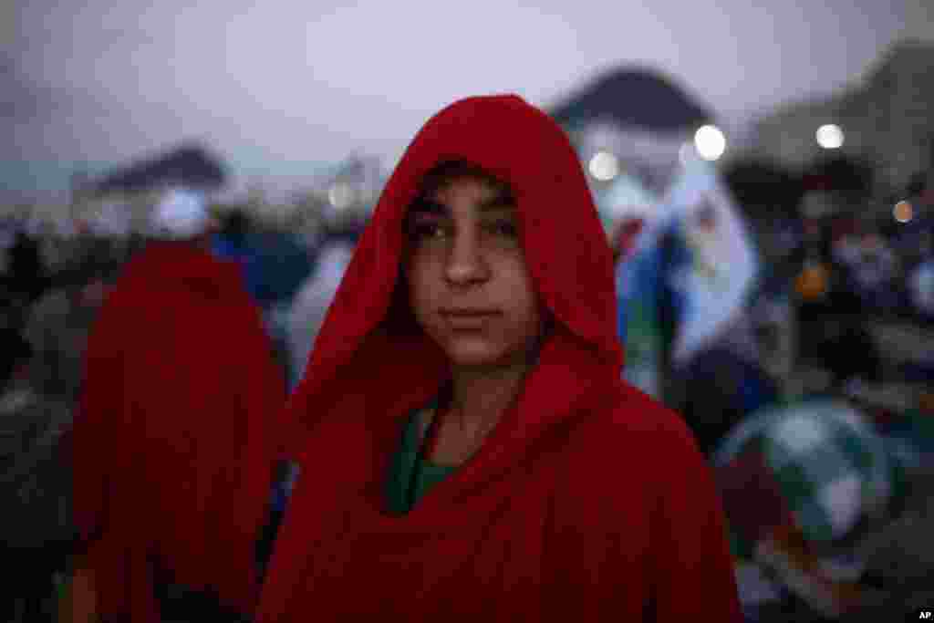 A pilgrim wakes up after a night of vigil in Copacabana beach in Rio de Janeiro, July 28, 2013.