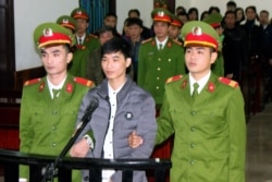 This photo from the Vietnam News Agency taken on Nov. 27, 2017, shows activist Nguyen Van Hoa standing trial at a local people's court in the central province of Ha Tinh.