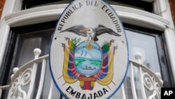 The Ecuadoran national emblem is attached to railings outside the country's embassy in London, Oct. 18, 2016. British officials have long expressed frustration at Ecuador's decision to let WikiLeaks founder Julian Assange take refuge in the embassy.