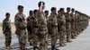 FILE - French troops stand at attention during a handover ceremony of the Timbuktu mission to Burkina Faso at Timbuktu airport on April 23, 2013. 