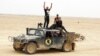 Iraqi soldiers flash victory signs after regaining control of the Ramadi Stadium and the neighboring al-Bugleeb area, Oct. 6, 2015.