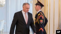 FILE - Slovak President Andrej Kiska arrives to speak at a press conference at the Presidential Palace in Bratislava, Slovakia, March, 20, 2018.