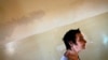 FILE - A patient is seen walking a hallway at a mental health institution in the Balkans.