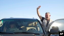 Jordan’s King Abdullah II, waves during a tour of the Baqura enclave formerly leased by Israel, with Crown Prince Hussein, left, and military officers, Nov. 11, 2019. 