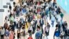 FILE - In this June 21, 2019, file photo commuters walk through a corridor in the World Trade Center Transportation Hub in New York. Millennial workers are more likely than older generations to…