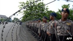 Barisan polisi di belakang kawat berduri di luar Istana presiden mengantisipasi demonstrasi anti-kenaikan BBM (19/11). (AFP/Romeo Gacad)