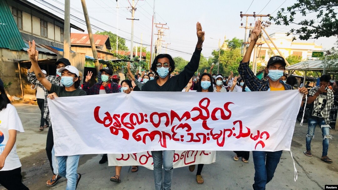 Students hold a banner and flash the three-finger salute as they take part in a protest against Myanmar’s junta, in Mandalay, Myanmar May 10, 2021. REUTERS/Stringer NO RESALES. NO ARCHIVES