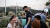 A waiter wears a protective face mask serves customers in a bar, amid the spread of the coronavirus disease (COVID-19), in Athens, Greece, Aug. 1, 2020.