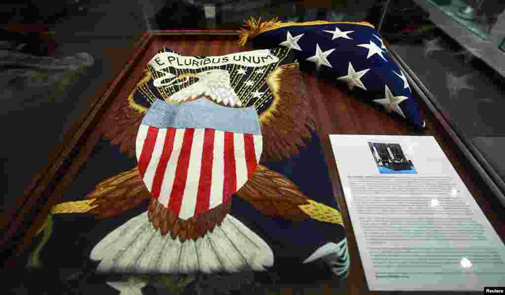 The flags that hung behind the desk of former President John Kennedy are seen at an auction house in New York, Oct. 17, 2013.
