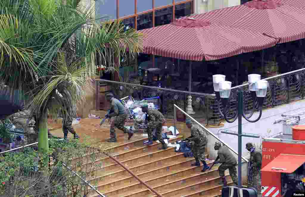 Kenya Defense Forces soldiers take their position at the Westgate Mall, on the fourth day since militants stormed into the mall, in Nairobi, Sept. 24, 2013.