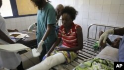 A woman is treated at the central hospital after a series of explosions destroyed homes and buildings in the Mpila neighborhood of Congo Republic's capital Brazzaville, March 5, 2012.