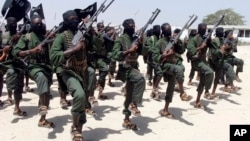 FILE - Al-Shabab fighters march during military exercises in the Lafofe area, 18 kilometers south of Mogadishu, Somalia, Feb. 17, 2011.
