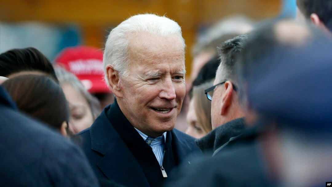 Former vice president Joe Biden talks with officials after speaking at a rally in support of striking Stop & Shop workers in Boston, April 18, 2019.